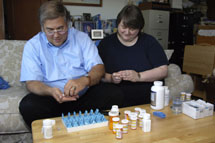 Rebecca Bryson and husband sort pills for her medical conditions